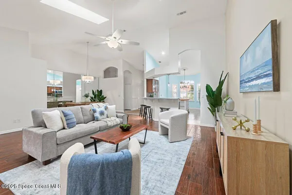 a living room with furniture and a chandelier