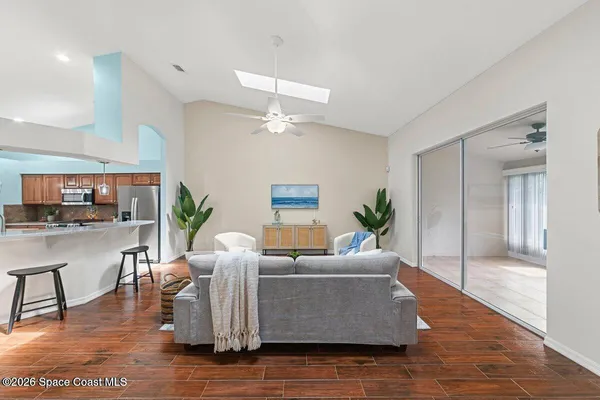 a living room with furniture and a wooden floor