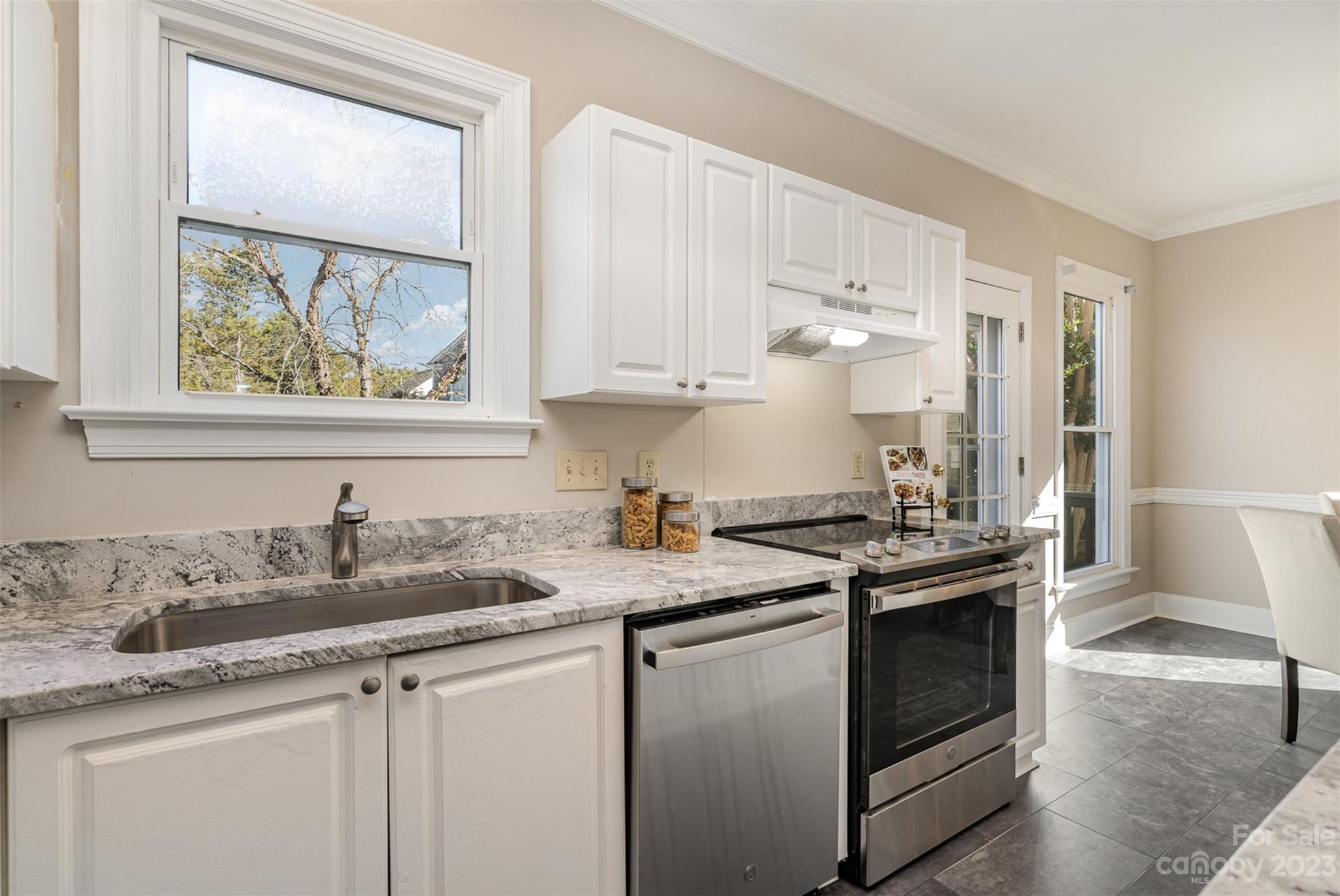 2906 Saintfield Place Charlotte, NC 28270 - Photo 12 of 37 a kitchen with stainless steel appliances granite countertop a sink stove and cabinets