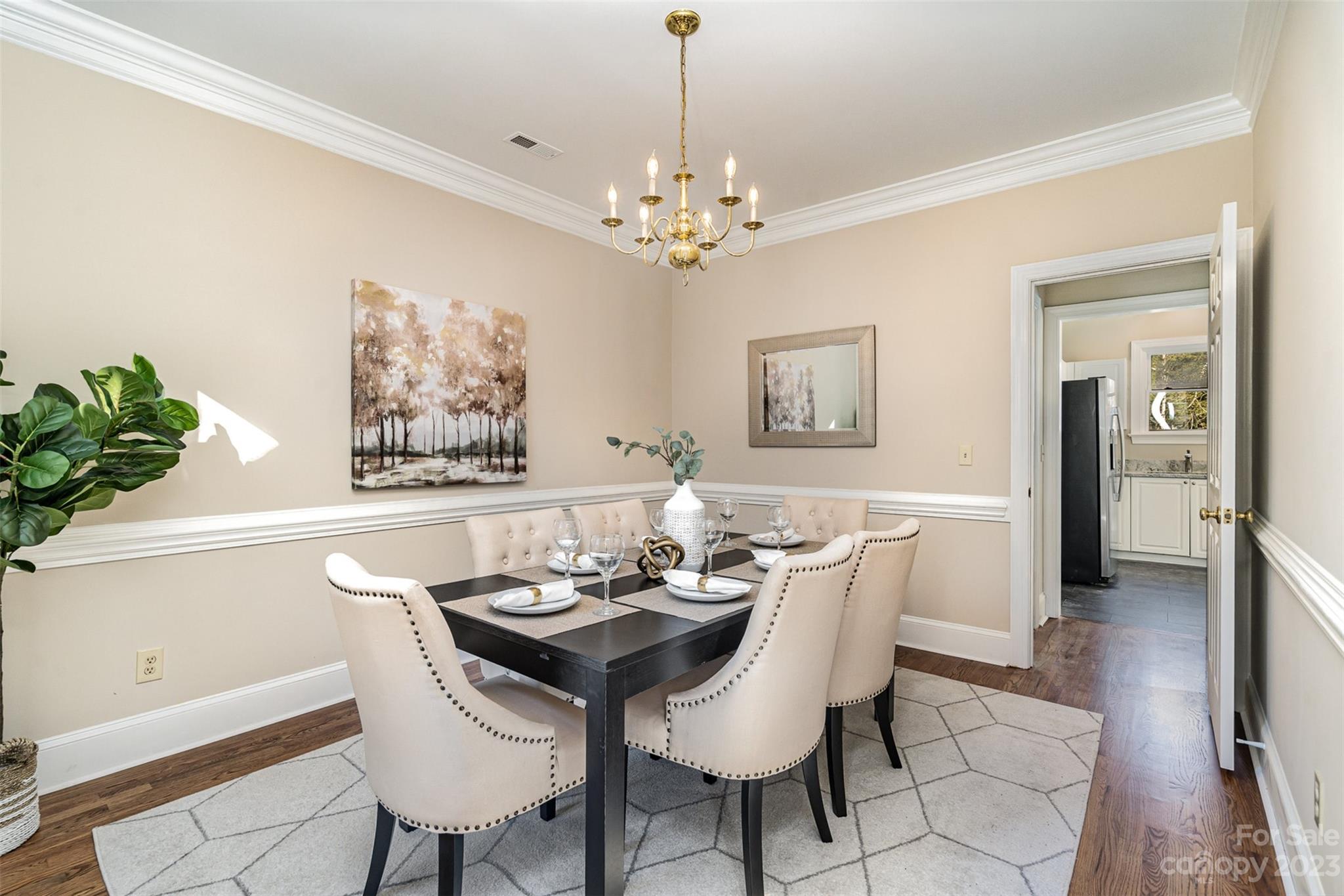 2906 Saintfield Place Charlotte, NC 28270 - Photo 15 of 37 a dining room with furniture potted plants and wooden floor