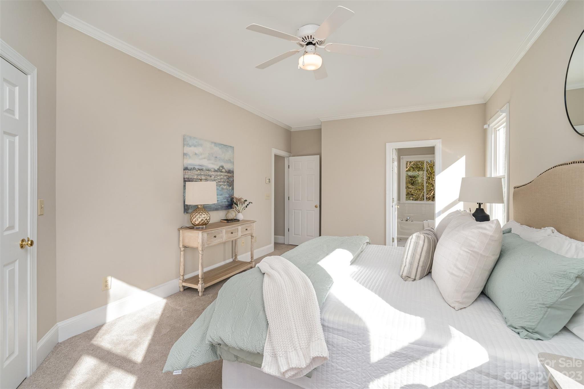 2906 Saintfield Place Charlotte, NC 28270 - Photo 20 of 37 a bedroom with a bed and a chandelier