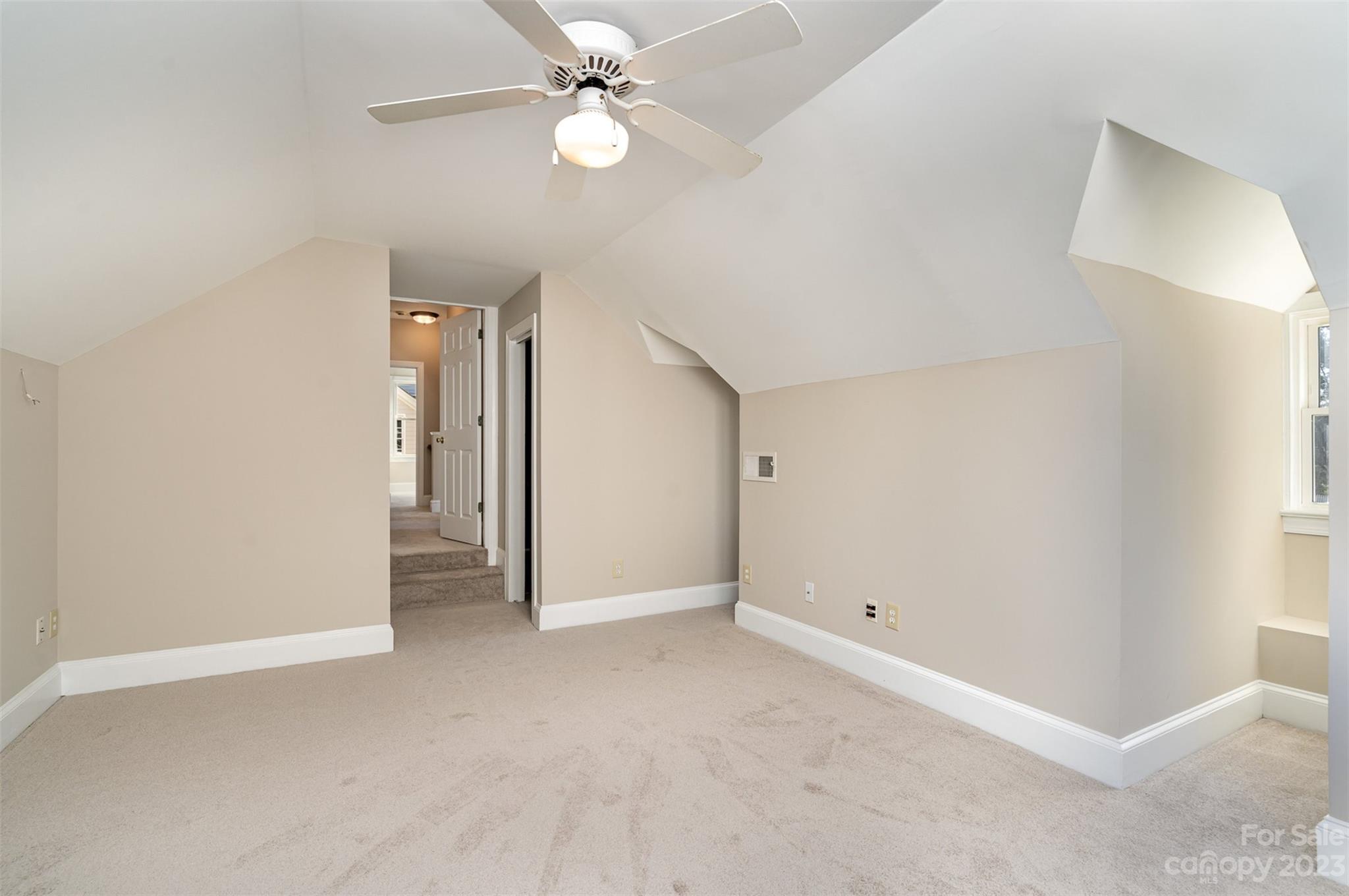 2906 Saintfield Place Charlotte, NC 28270 - Photo 27 of 37 an empty room with a ceiling fan and a window