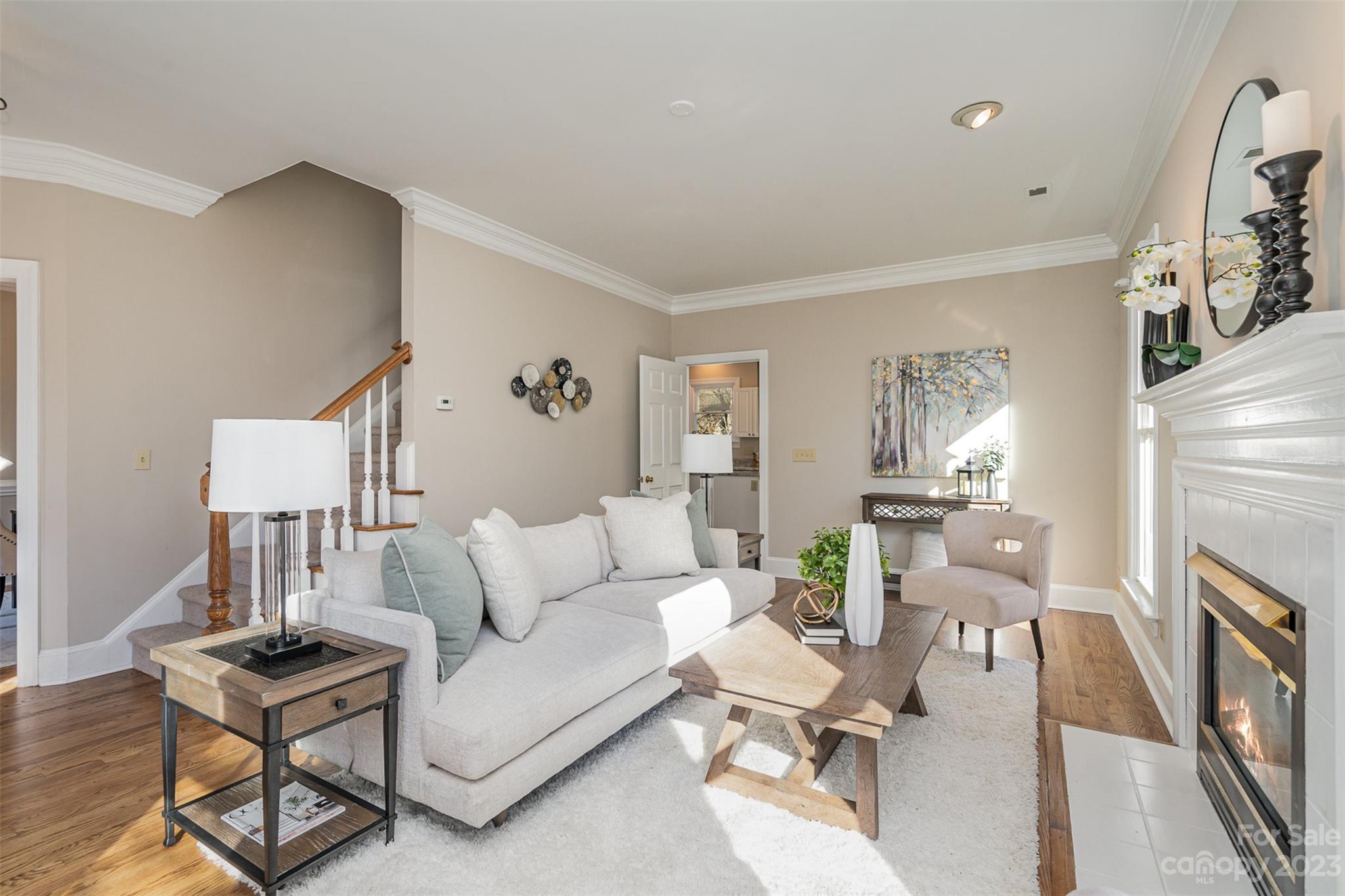 2906 Saintfield Place Charlotte, NC 28270 - Photo 4 of 37 a living room with furniture a fireplace and a table