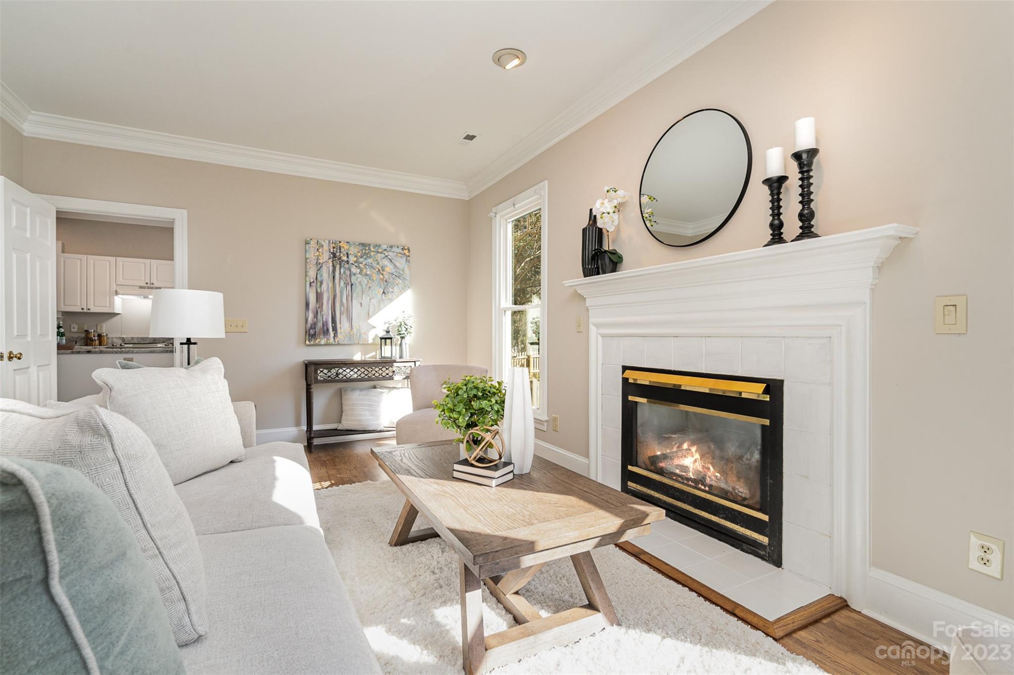 2906 Saintfield Place Charlotte, NC 28270 - Photo 5 of 37 a living room with furniture a fireplace and a mirror