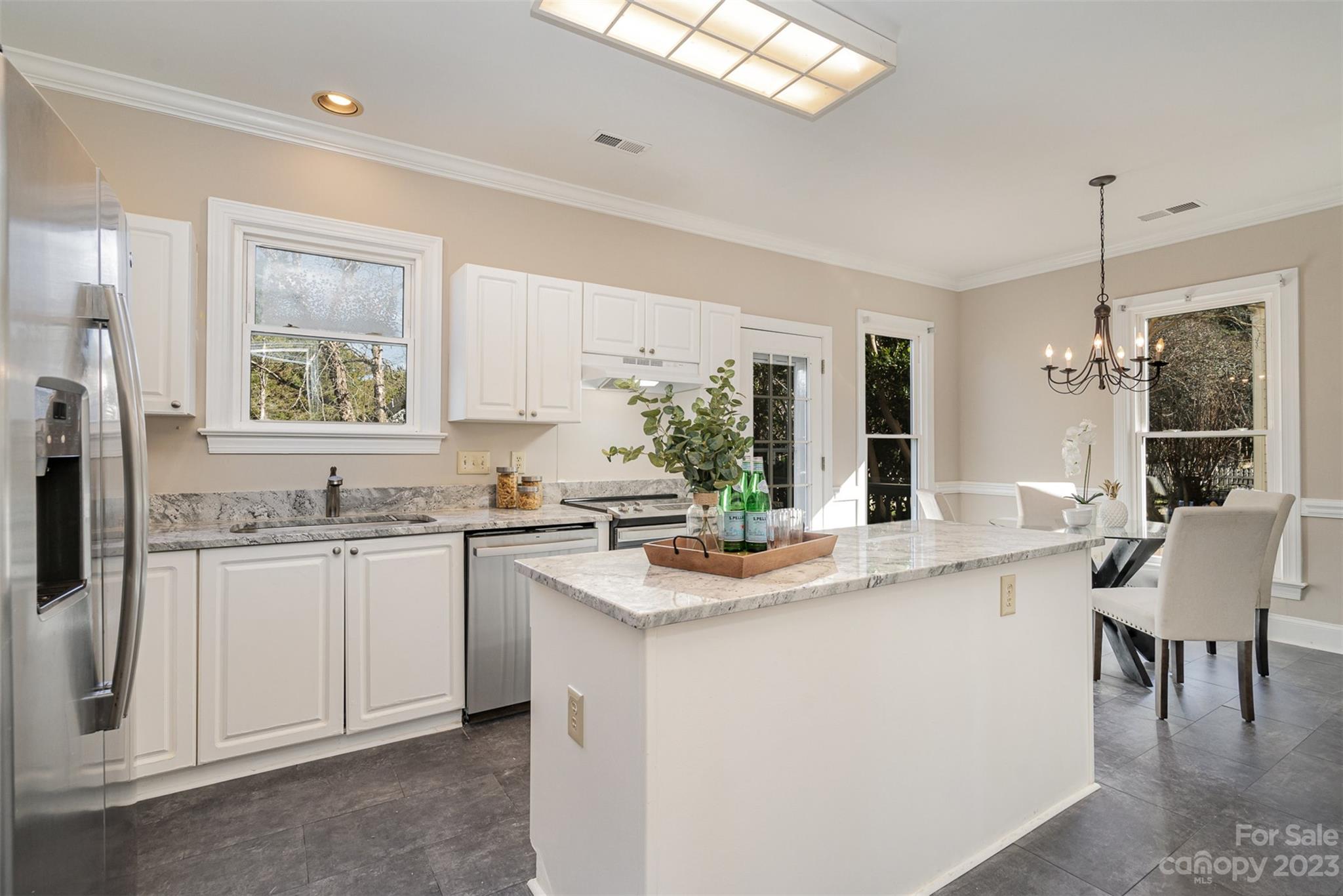 2906 Saintfield Place Charlotte, NC 28270 - Photo 8 of 37 a kitchen with granite countertop white cabinets and white appliances