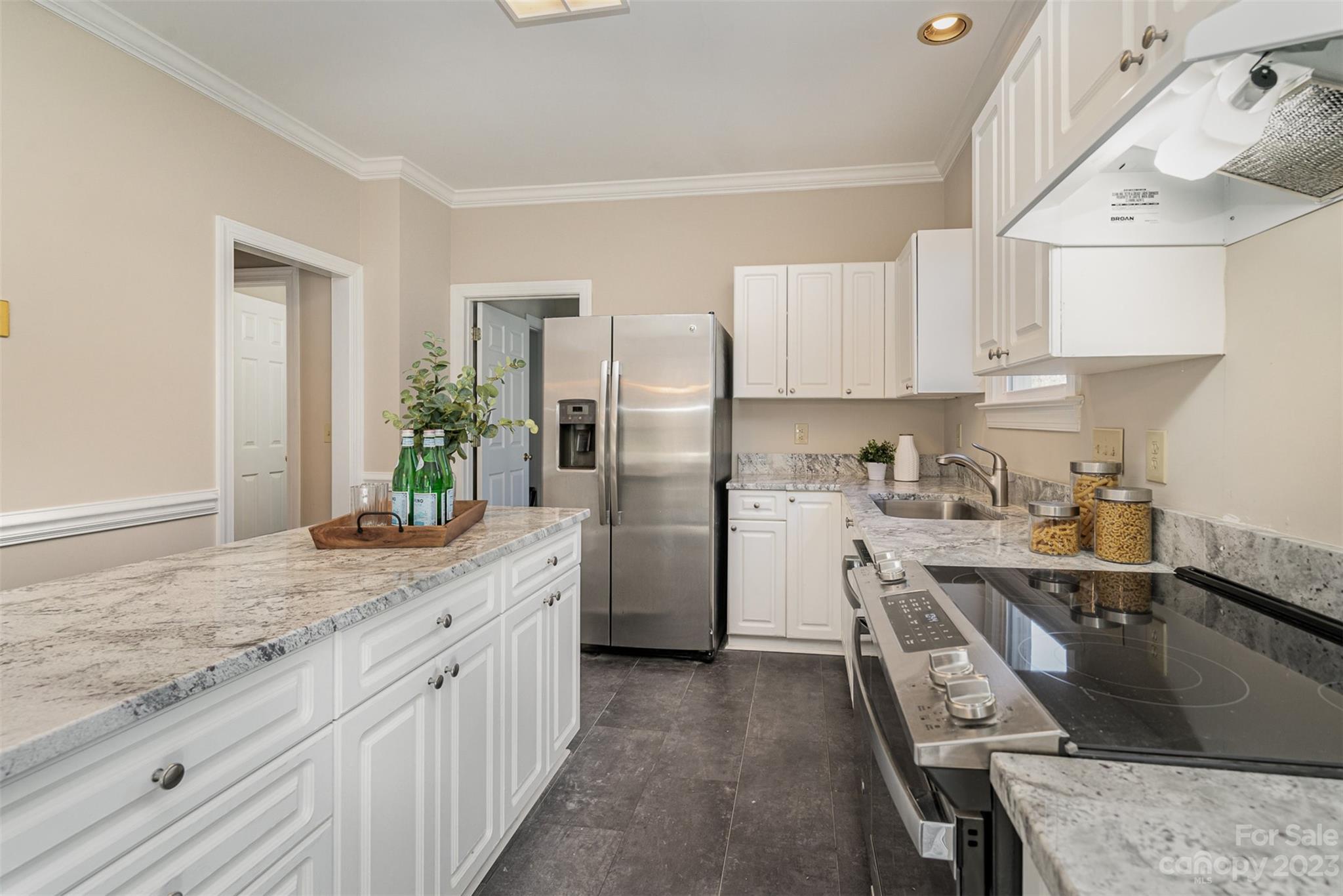 2906 Saintfield Place Charlotte, NC 28270 - Photo 10 of 37 a kitchen with stainless steel appliances granite countertop a sink stove and refrigerator
