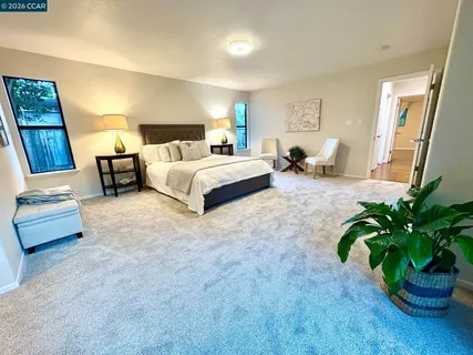a bedroom with a bed and a large window