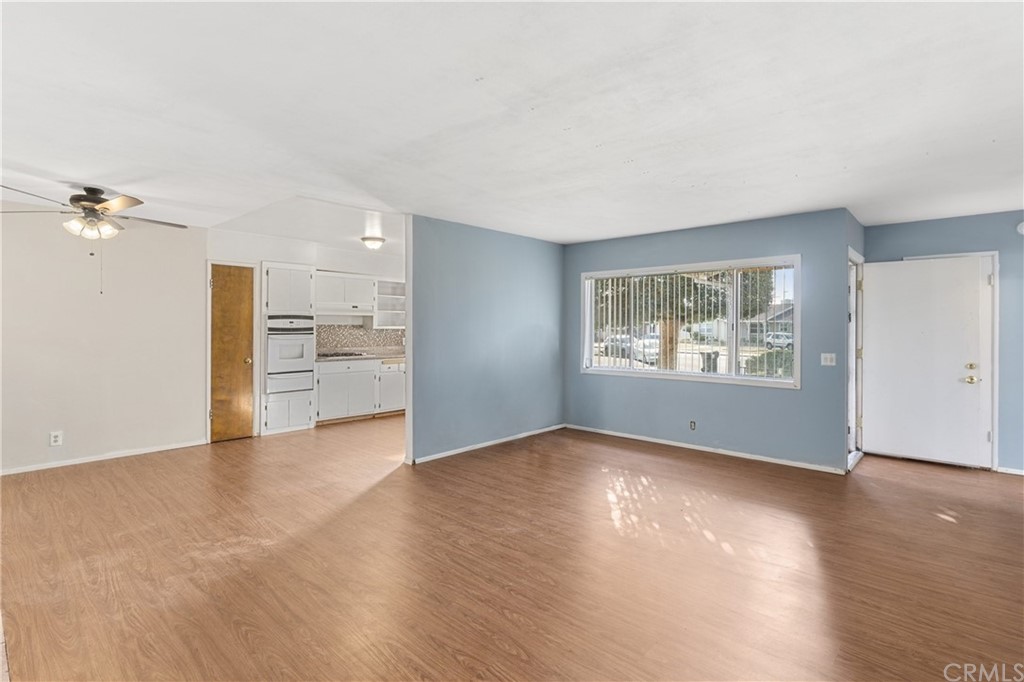 12042 Hackamore Road Garden Grove, CA 92840 - Photo 4 of 20 a view of an empty room with a window and wooden floor