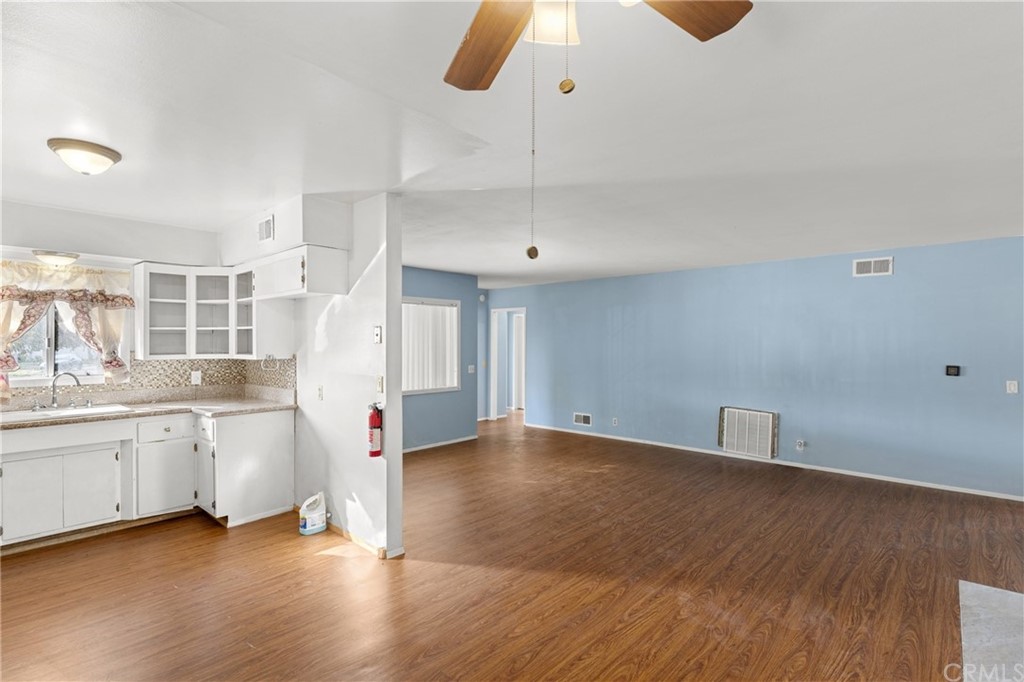 12042 Hackamore Road Garden Grove, CA 92840 - Photo 5 of 20 an empty room with wooden floor and windows
