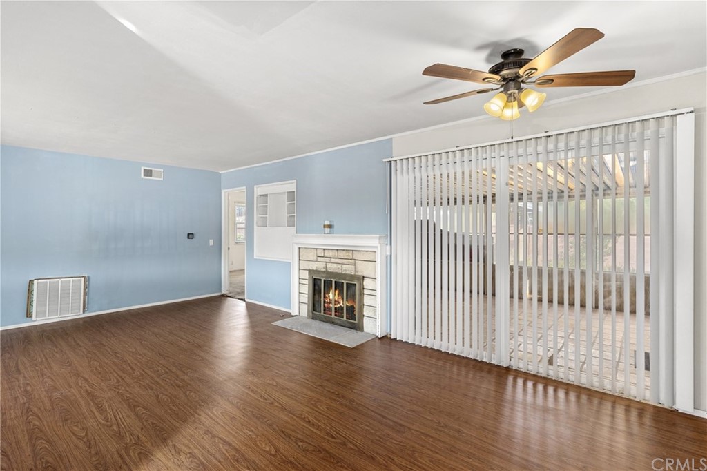 12042 Hackamore Road Garden Grove, CA 92840 - Photo 6 of 20 a view of an empty room with wooden floor and a window