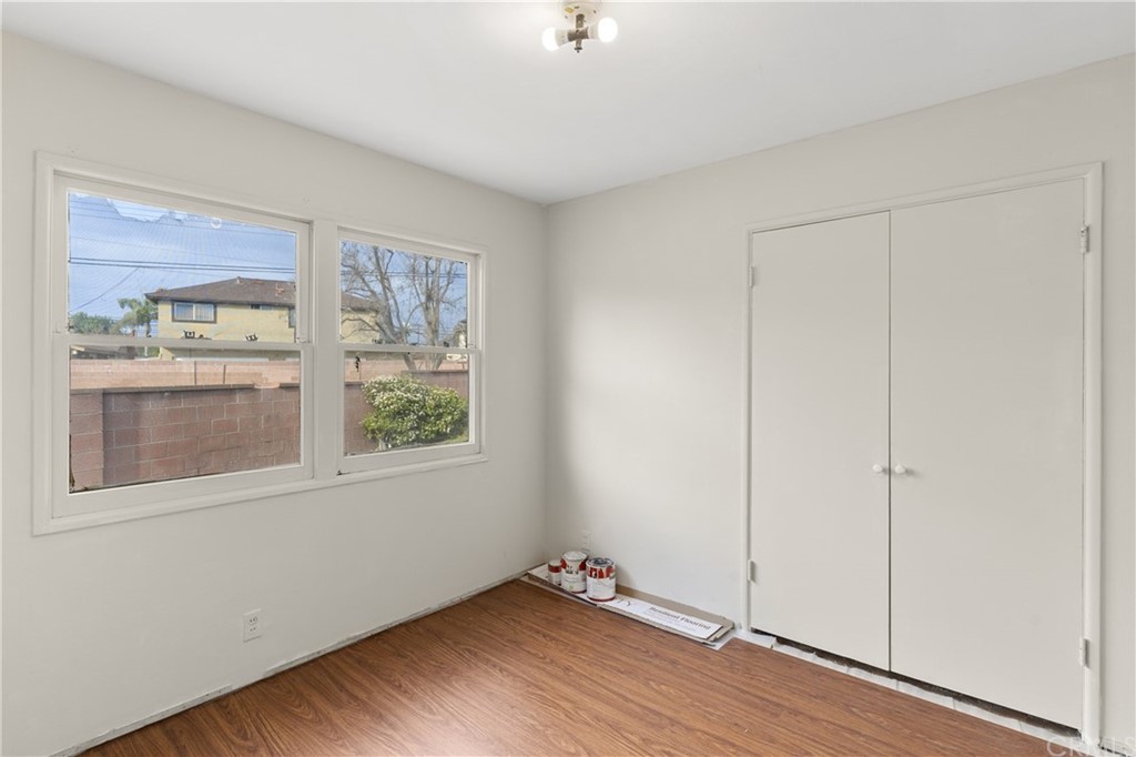 12042 Hackamore Road Garden Grove, CA 92840 - Photo 8 of 20 a view of an empty room with window and wooden floor