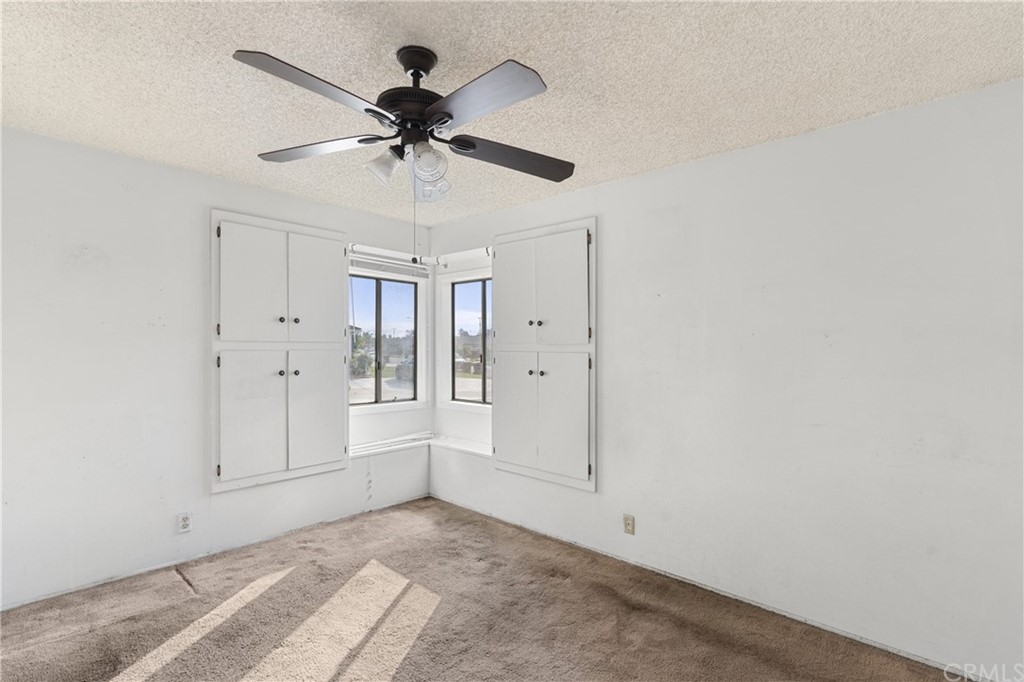 12042 Hackamore Road Garden Grove, CA 92840 - Photo 9 of 20 an empty room with fan and windows