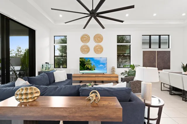 a bedroom with a bed and a flat tv screen on the dresser