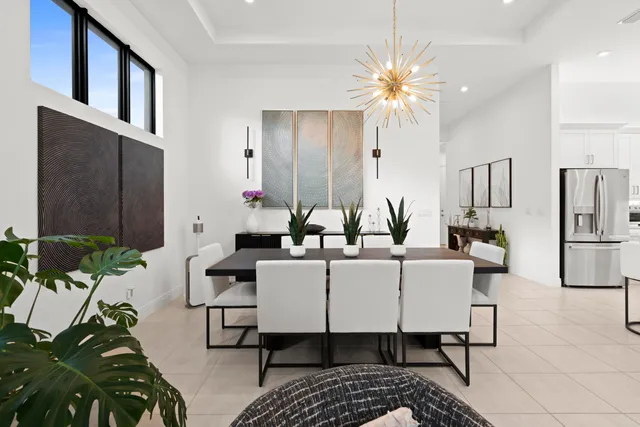 a view of a patio with dining table and chairs with a couches and a fireplace