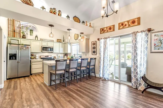 a view of a dining room with furniture large window and wooden floor