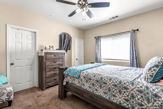 a bedroom with a bed and a chandelier