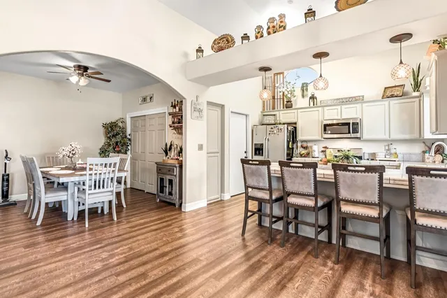 a view of a dining room with furniture and wooden floor