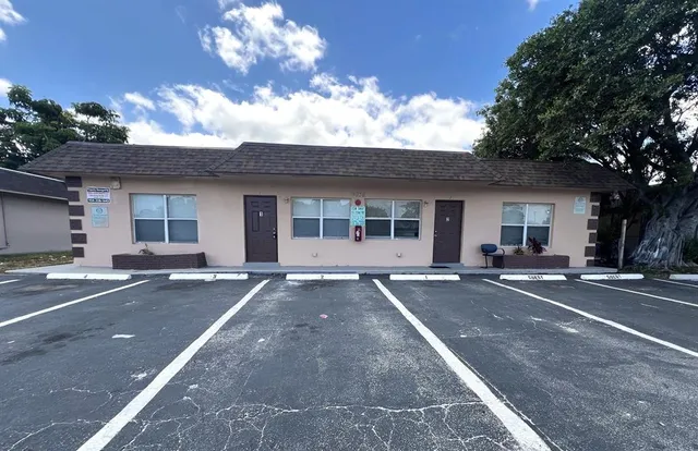 a front view of a house with a garden and patio
