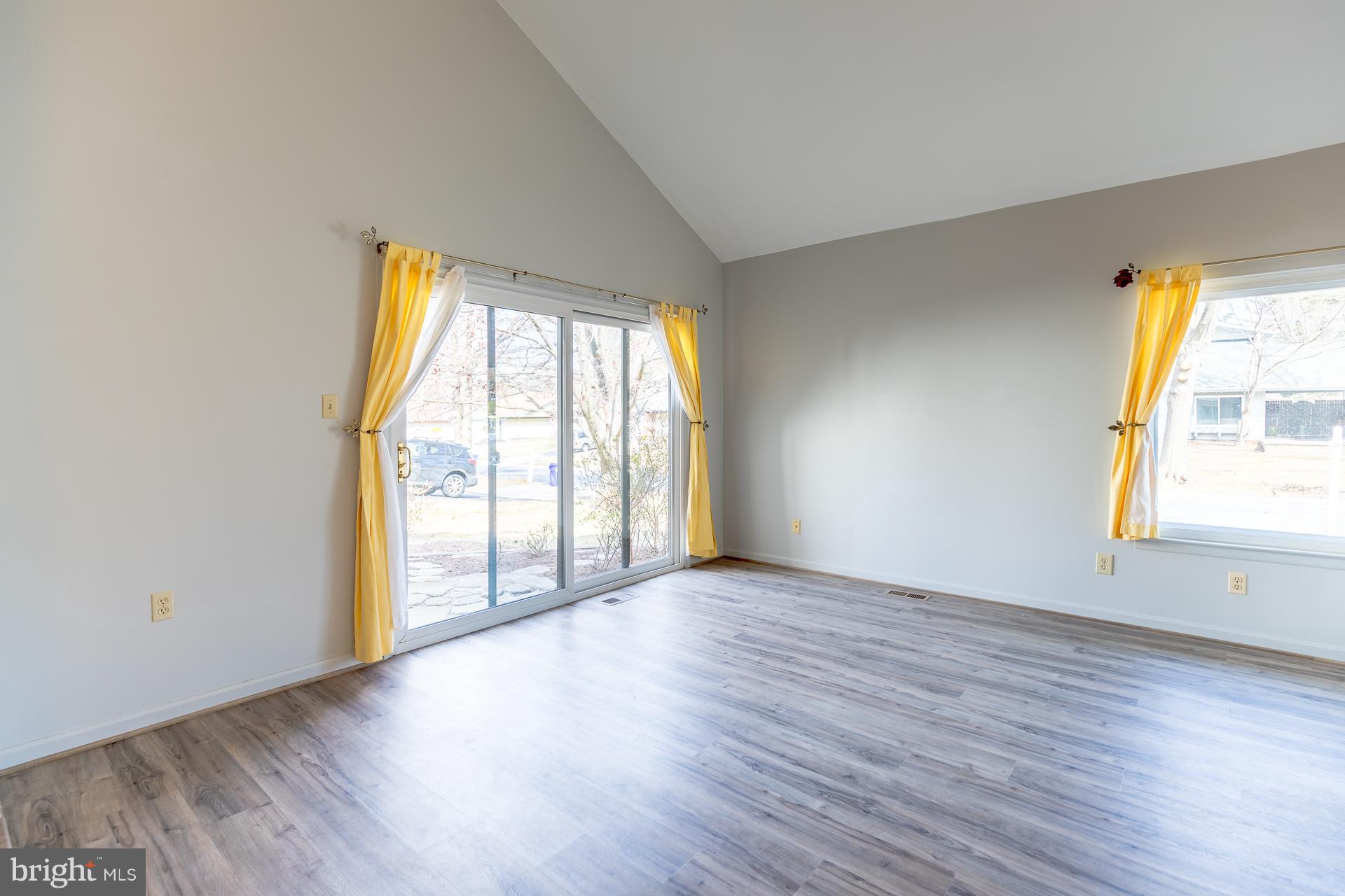 9124 Tulip Grove Road Gaithersburg, MD 20879 - Photo 14 of 20 an empty room with wooden floor and windows