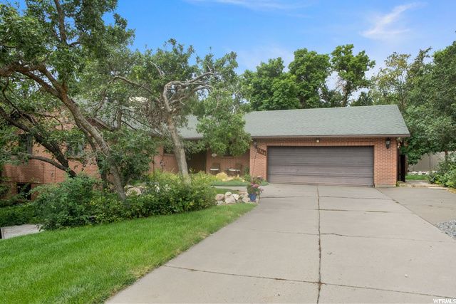 1545 Nicholls Road Fruit Heights, UT 84037 - Photo 1 of 1 View of front facade with garage and a front lawn