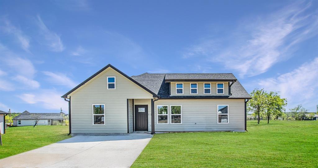 a front view of house with yard and green space