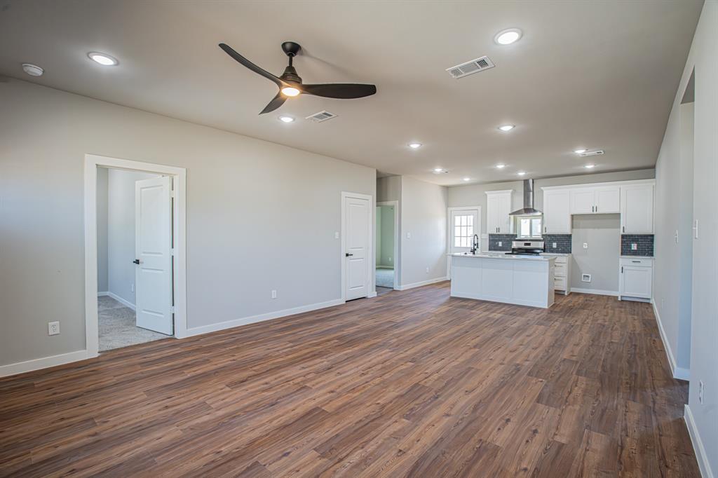 124 Brookview Drive Jacksboro, TX 76458 - Photo 11 of 34 a view of kitchen with wooden floor and window