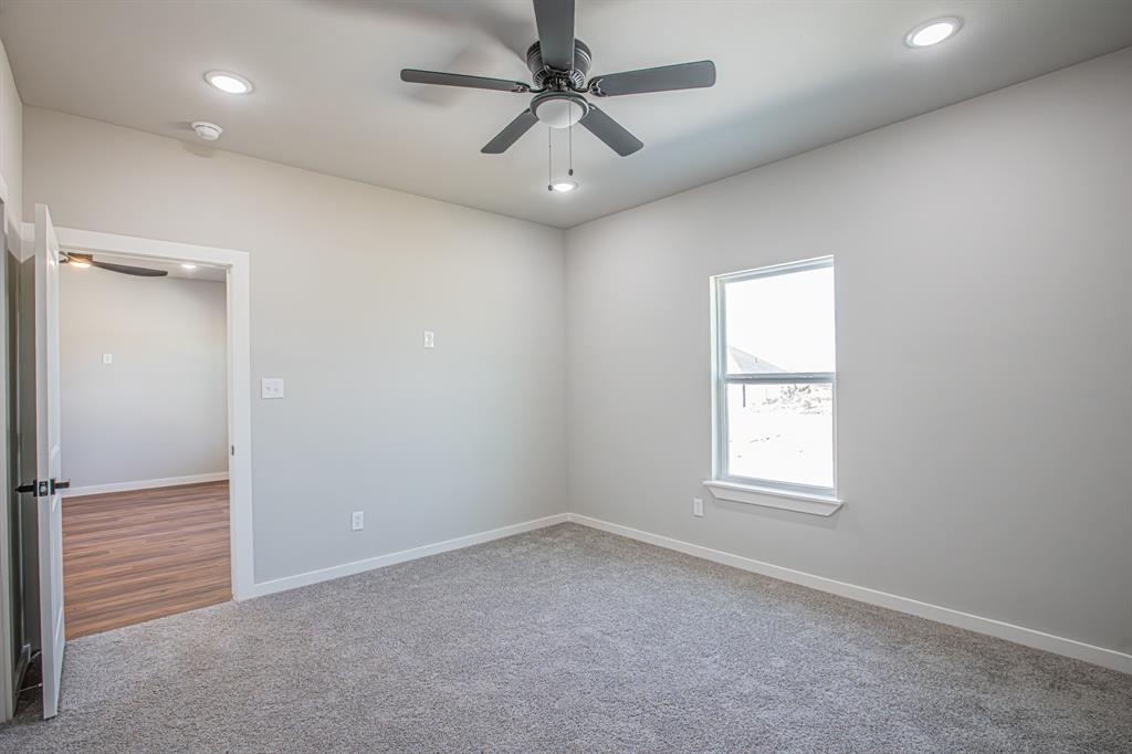 124 Brookview Drive Jacksboro, TX 76458 - Photo 15 of 34 an empty room with windows and fan