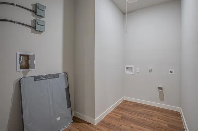 a view of a room with wooden floor