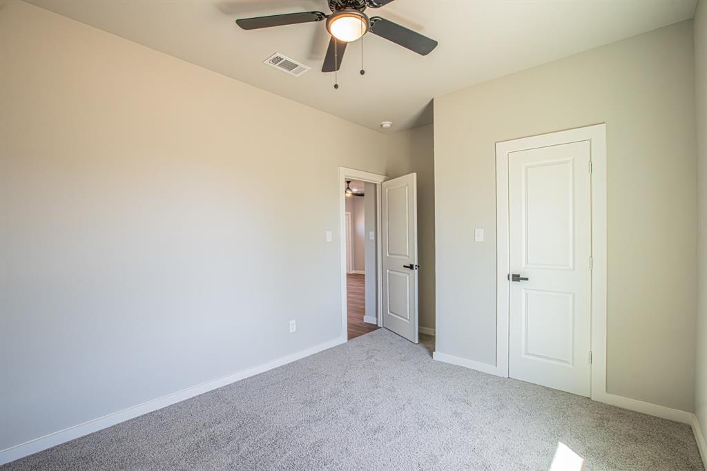 124 Brookview Drive Jacksboro, TX 76458 - Photo 23 of 34 an empty room with fan and entrance