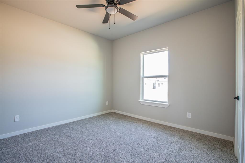124 Brookview Drive Jacksboro, TX 76458 - Photo 26 of 34 an empty room with a window and ceiling fan
