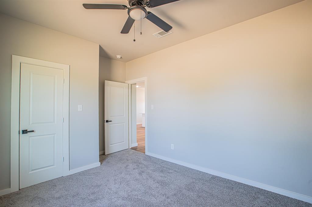 124 Brookview Drive Jacksboro, TX 76458 - Photo 28 of 34 an empty room with a ceiling fan and a window