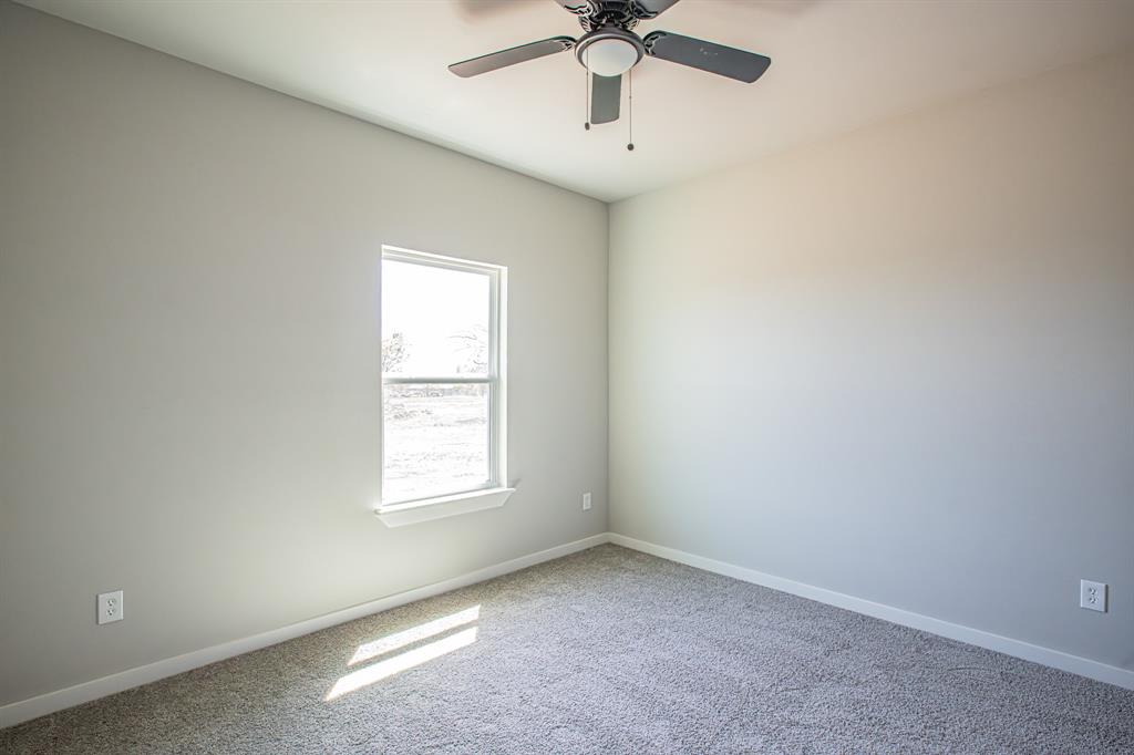 124 Brookview Drive Jacksboro, TX 76458 - Photo 32 of 34 an empty room with a window and a fan