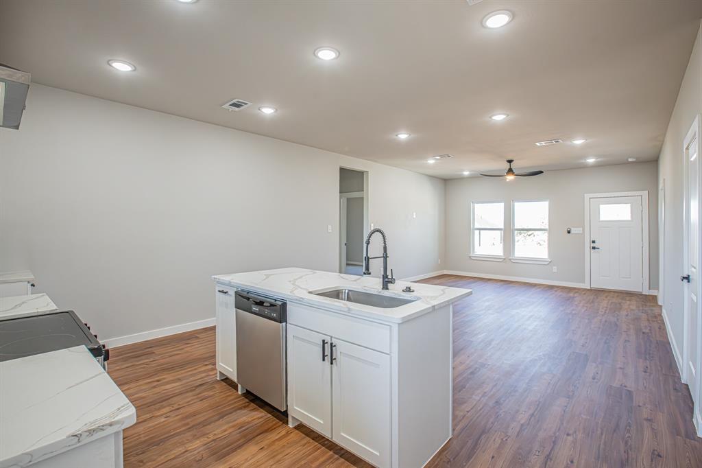 124 Brookview Drive Jacksboro, TX 76458 - Photo 6 of 34 a view of a kitchen with a sink wooden floor and a window