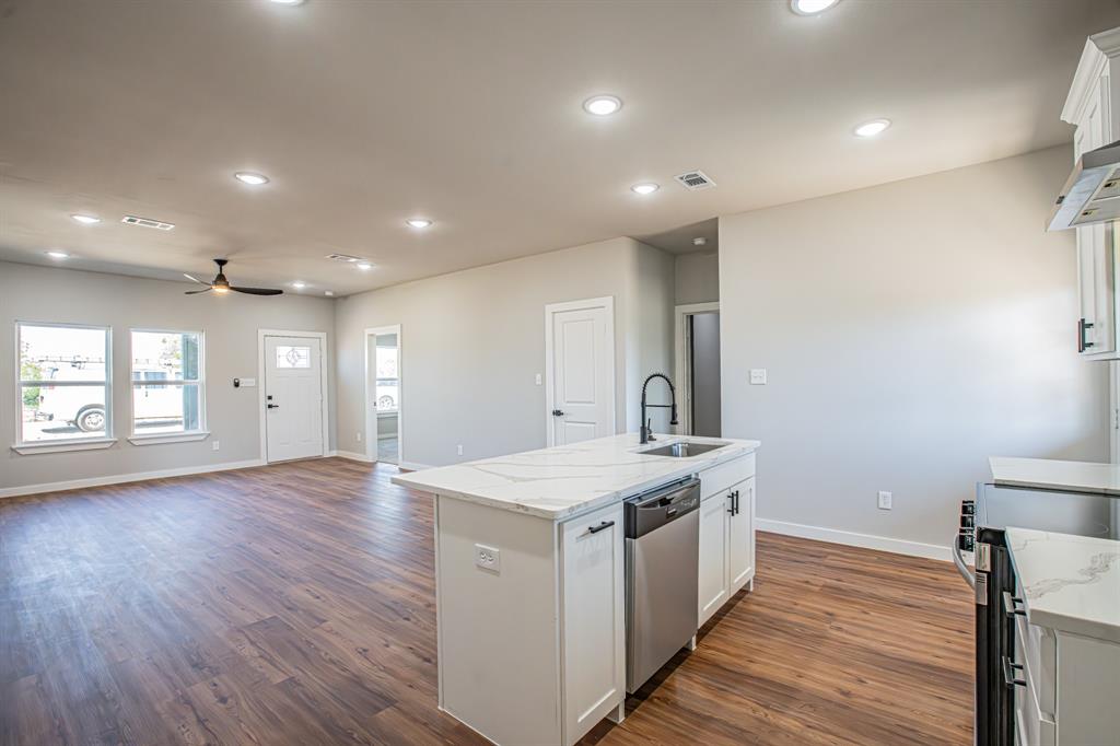124 Brookview Drive Jacksboro, TX 76458 - Photo 8 of 34 a large kitchen with stainless steel appliances a large counter top a sink and a refrigerator