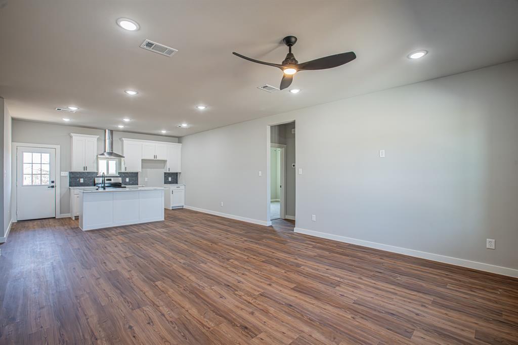 124 Brookview Drive Jacksboro, TX 76458 - Photo 10 of 34 a view of kitchen with wooden floor and window