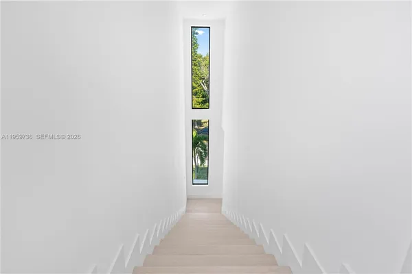 a bedroom with double bed and a large window