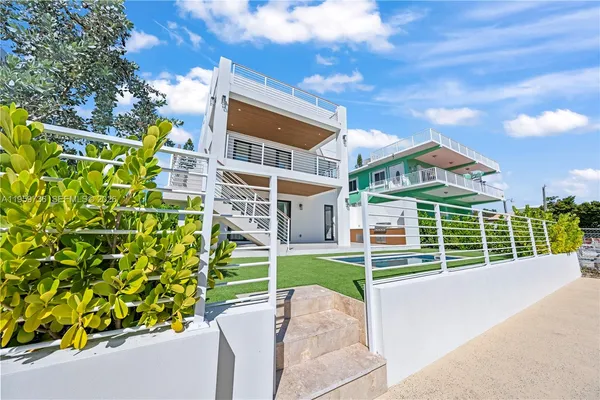 a view of a house with backyard and a kitchen