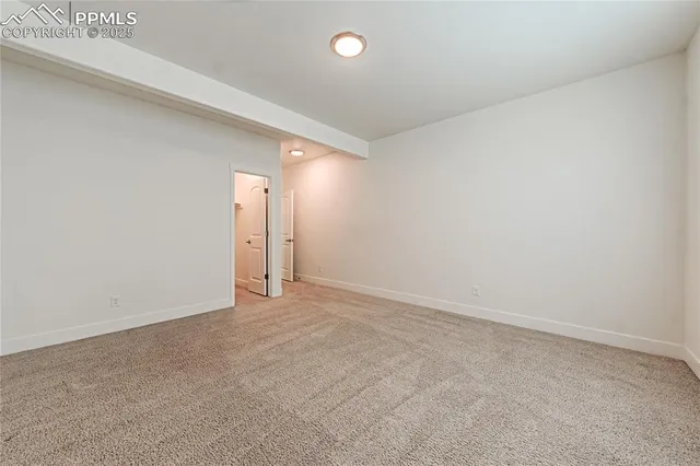 an empty room with closet area and windows