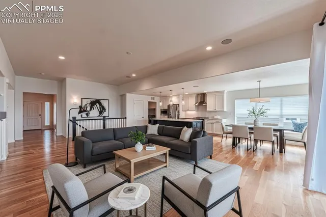 a living room with furniture and wooden floor