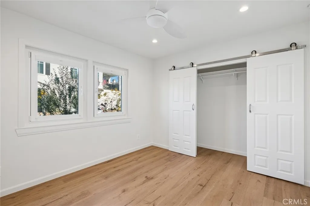620 Acacia Avenue Corona del Mar, CA 92625 - Photo 14 of 24 a view of an empty room with wooden floor and a window