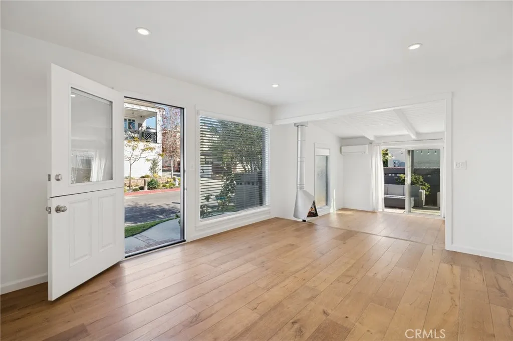 620 Acacia Avenue Corona del Mar, CA 92625 - Photo 18 of 24 a view of an empty room with wooden floor and a window