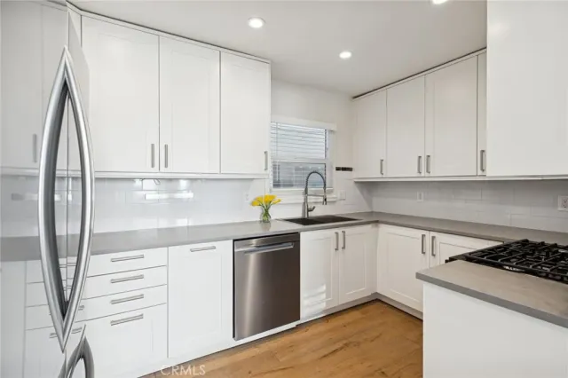 a kitchen with appliances cabinets and a sink