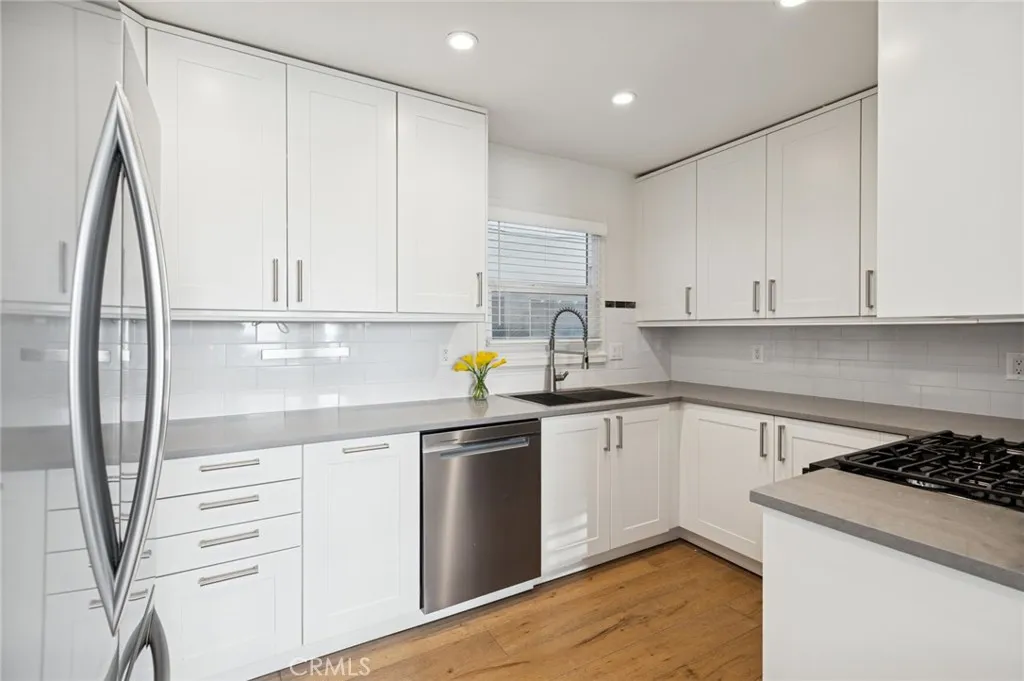 620 Acacia Avenue Corona del Mar, CA 92625 - Photo 4 of 24 a kitchen with appliances cabinets and a sink