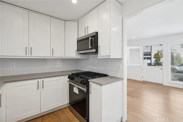 a view of a kitchen with electric appliances
