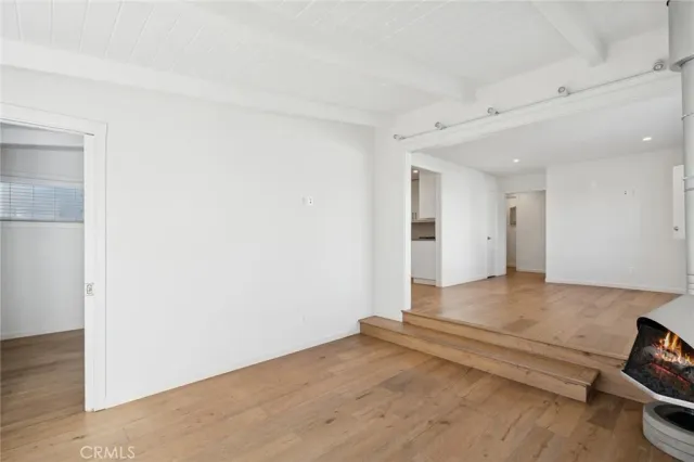 a view of an empty room and wooden floor