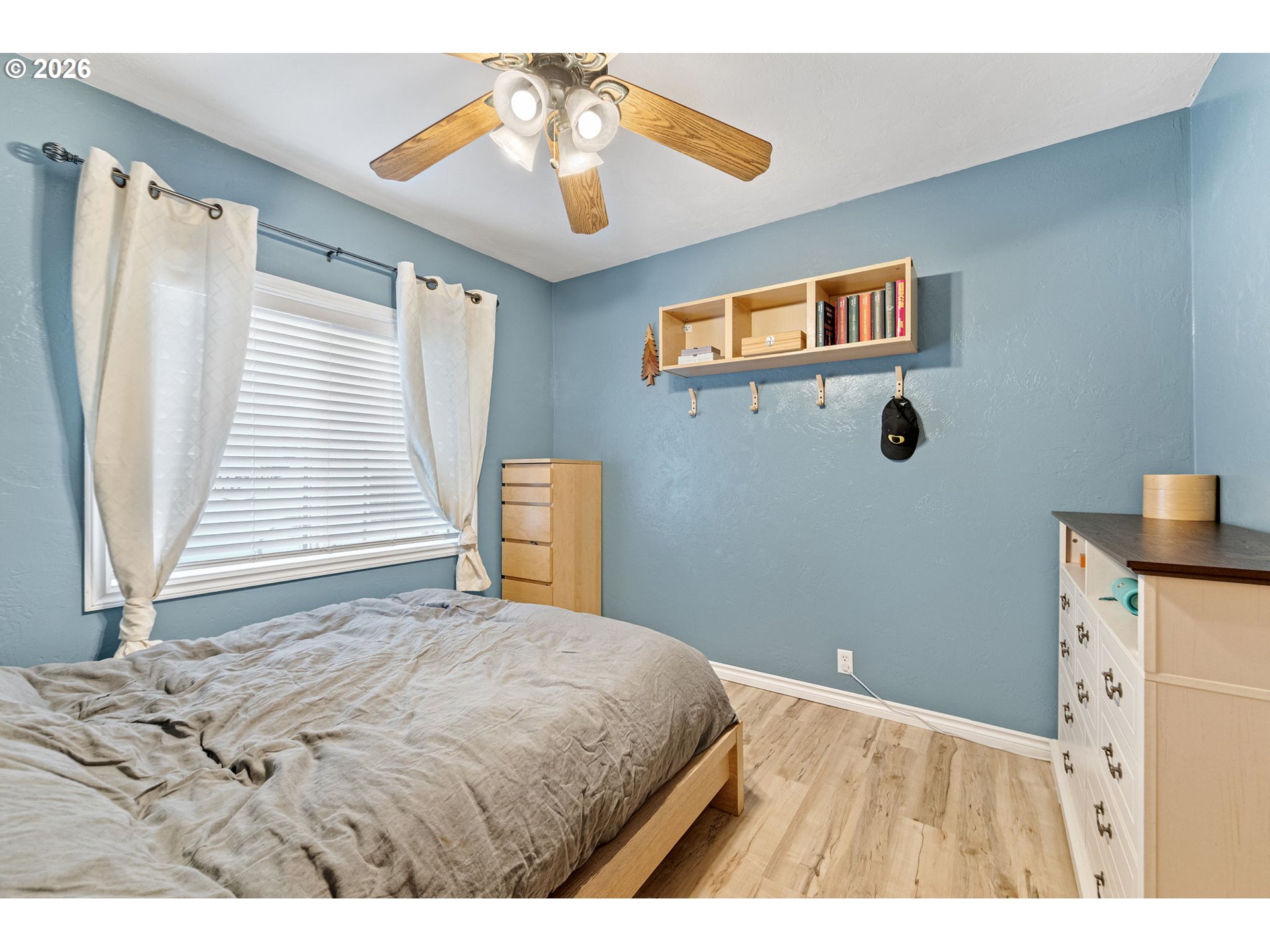 74129 London Road Cottage Grove, OR 97424 - Photo 16 of 44 a bedroom with a bed and a chandelier