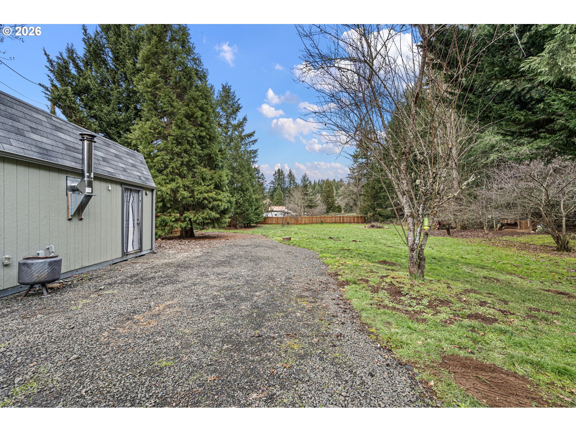 74129 London Road Cottage Grove, OR 97424 - Photo 28 of 44 a view of a backyard with large trees