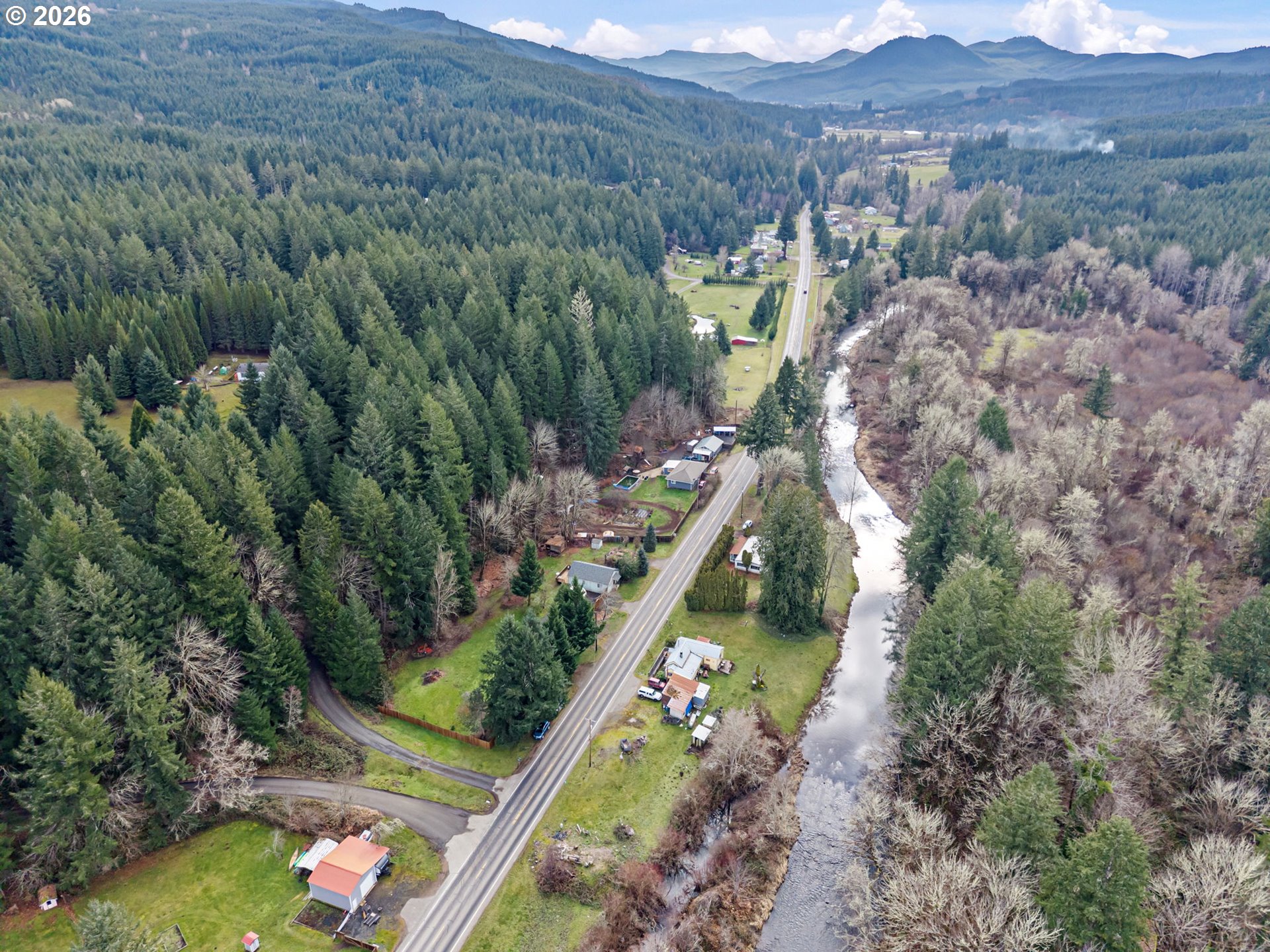 74129 London Road Cottage Grove, OR 97424 - Photo 38 of 44 an aerial view of green landscape with trees houses and mountain view