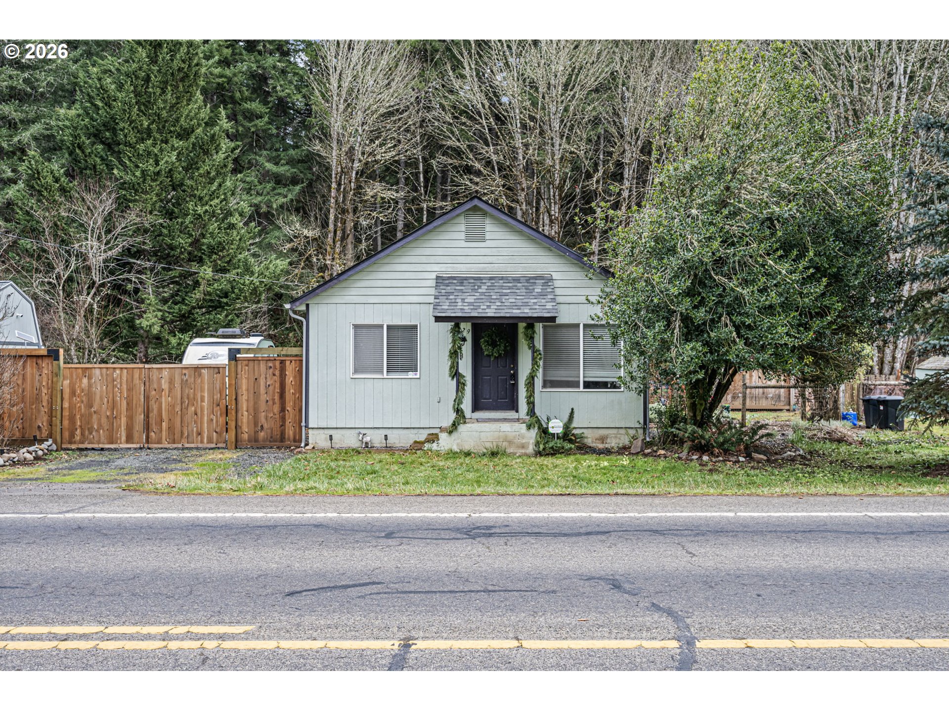 74129 London Road Cottage Grove, OR 97424 - Photo 4 of 44 a front view of a house with a yard and potted plants