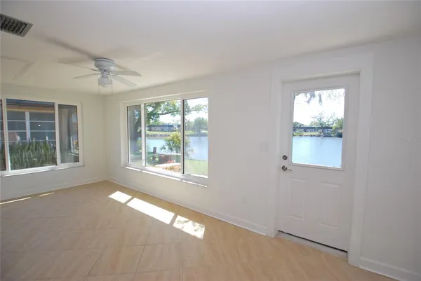 an empty room with windows and closet